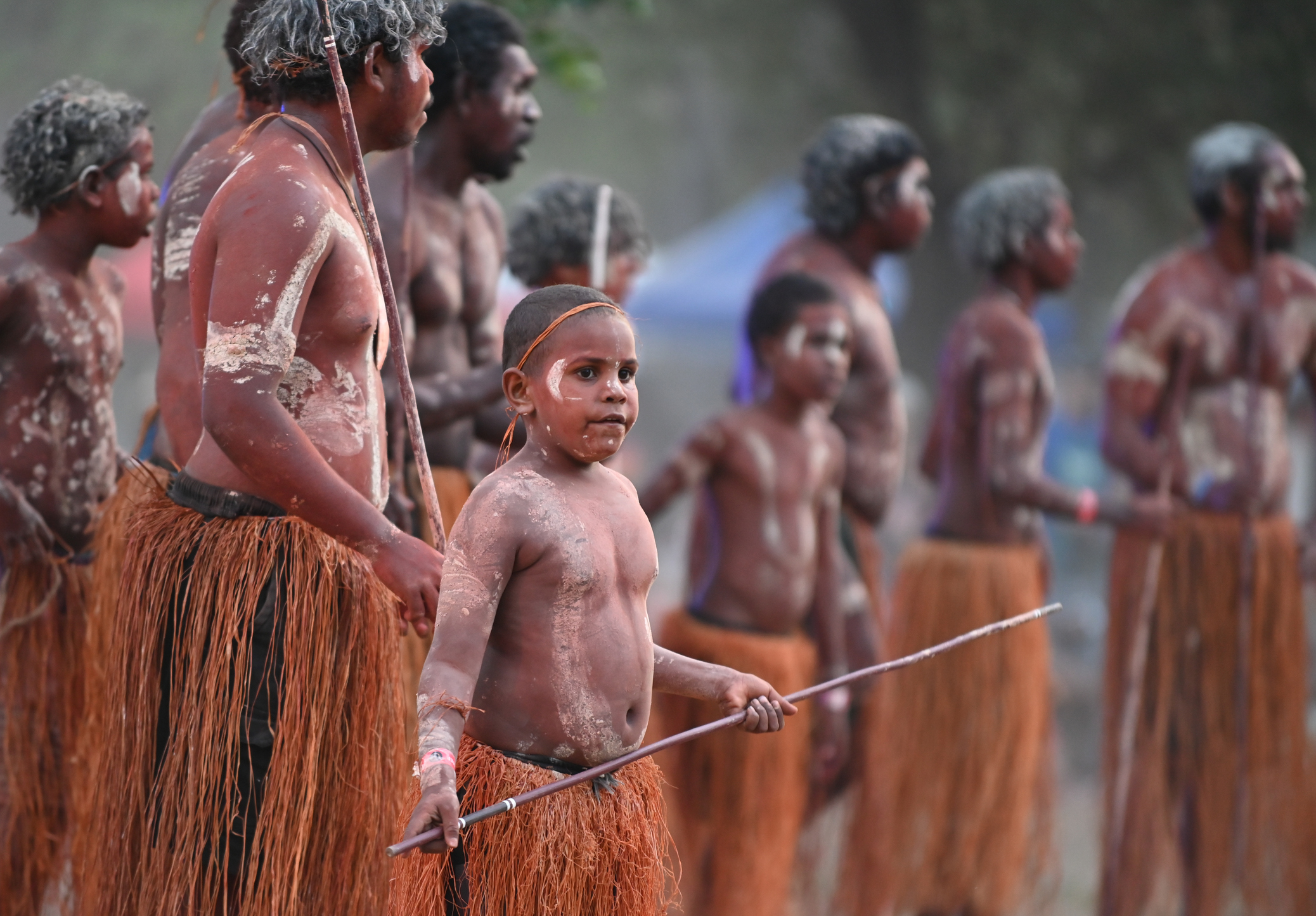 Indigenous Australians men on ceremonial dance in Laura Quinkan Dance Festival Cape York Australia. Ceremonies combine dance, song, rituals, body decorations and costumes