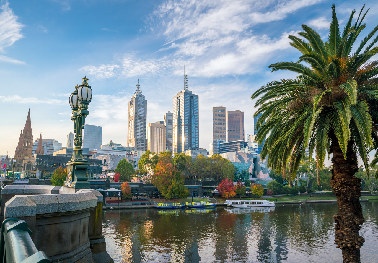 Melbourne city skyline with tall buildings and skyscrapers against a clear blue sky