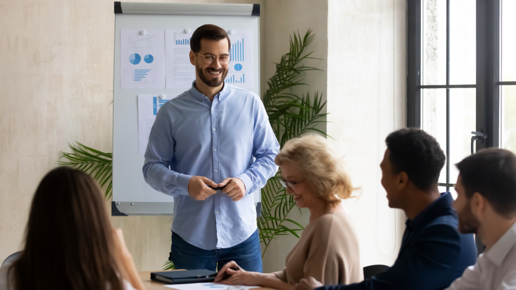 A man presenting to colleagues in a conference room.