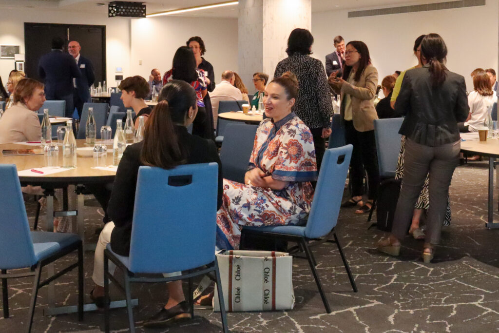 People chat at a conference